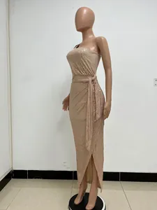 Side view of elegant rose gold one-shoulder sequin evening maxi dress with waist tie detail