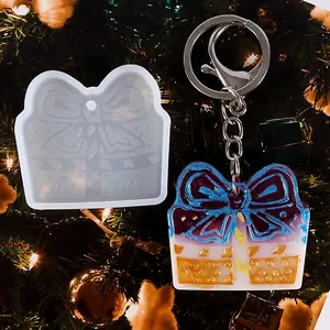 Close-up of Christmas gift box silicone mold and glitter resin keychain pendant