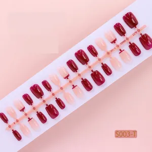 Detail view of 30pcs red gradient press-on nail tips on a strip in XS, S, M sizes.