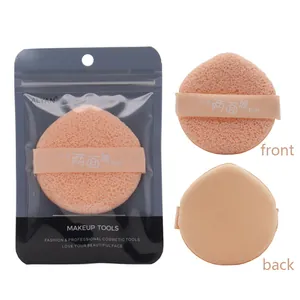 Detail view of double-sided peach makeup sponge puff with professional packaging.