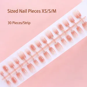 High-resolution detail of 30pcs gradient pink press-on nails on a size-coded plastic strip.