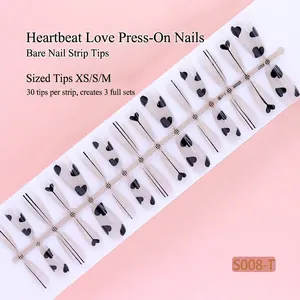 Close-up of 30pcs translucent nude press-on nail tips with black heart and line patterns