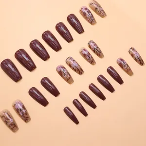 Detailed view of caramel brown and vintage floral press-on nails with long coffin shape
