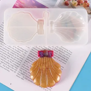 Detailed view of DIY shell-shaped silicone mold and finished golden resin makeup mirror