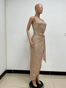 Side view of a rose gold one-shoulder sequin evening dress with pleated details and waist tie