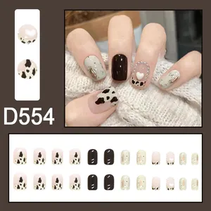 Detailed view of elegant cow print and heart-accented press-on nails in SKU D554 style.