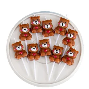 Set of cute brown teddy bear cake candles with red heart details for birthday party
