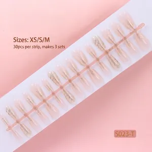 Detail of nude press-on nails with fine glitter finish in 30pcs strip packaging