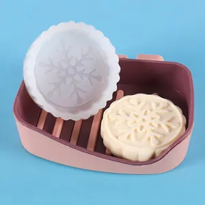 Detailed close-up of a round snowflake pattern silicone mold for DIY soap and wax candle making