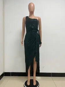 Close-up detail of dark green one-shoulder sequin maxi dress with elegant waist tie