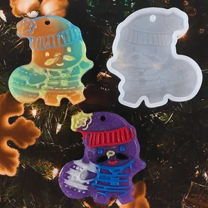 Close-up of DIY snowman resin mold and colorful finished charms on a Christmas tree
