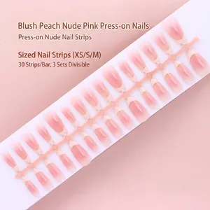 Macro view of blush peach nude pink gradient press-on nail strip with 30 pieces set