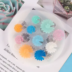 Close-up of silicone mold with colorful DIY daisy fondant flower decorations