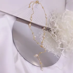 Detail view of a French gold Y-shaped necklace with natural freshwater pearls
