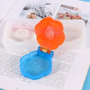 Detail view of DIY rose-shaped resin compact mirror with its silicone casting mold.