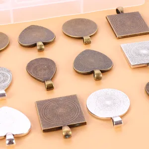 Macro view of assorted bronze and silver metal pendant trays for DIY jewelry making