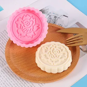 Detailed view of the rose flower silicone mold and the finished white wax melt on a tray