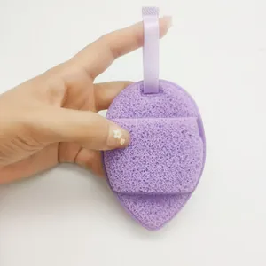 Macro detail of a purple teardrop-shaped facial cleansing sponge with a convenient strap