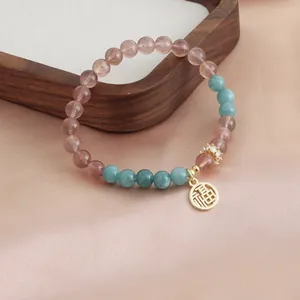 Exquisite natural strawberry quartz and turquoise beaded bracelet with a golden Fu charm detail