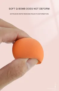 Macro shot of orange beauty blender being squeezed to show elastic rapid rebound texture
