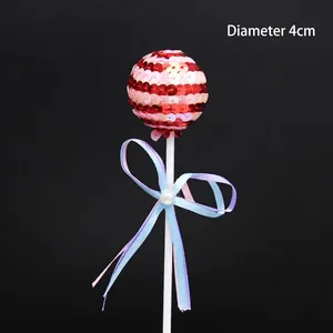 Sparkling sequined sphere cake topper with elegant ribbon bow for birthday desserts