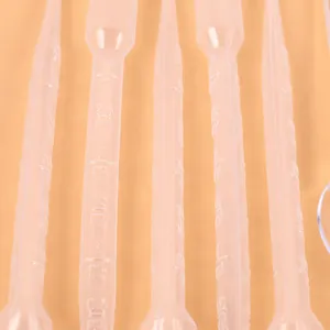 Detail view of 3ml disposable plastic transfer pipettes with clear measurement scales