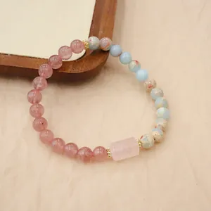 Detailed view of a handmade natural stone bracelet with pink quartz and blue jasper beads