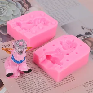 Pink silicone mold for unicorn figurines shown together with a finished resin craft