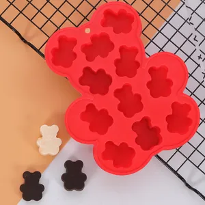 Red bear-shaped silicone mold for baby food and chocolates with finished bear samples