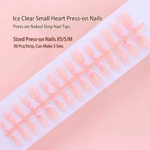 Detail view of 30-piece strip pink French press-on nails with heart patterns