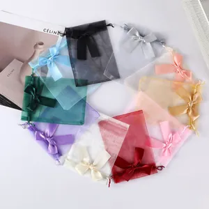 Detailed view of colorful organza jewelry bags with elegant satin bows
