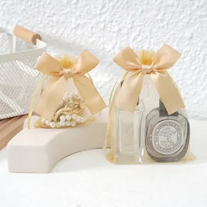 Elegant champagne organza jewelry gift bags with large satin bow and drawstring closure