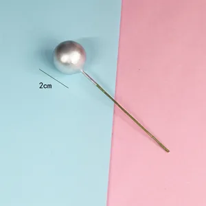 Close-up of a 2cm silver ball cake topper with wire stem for party decoration