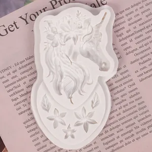 Close-up macro view of white silicone unicorn head and flower fondant mold for DIY crafts