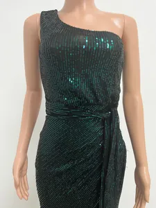 Detailed view of elegant black and green sequined one-shoulder maxi dress with waist tie
