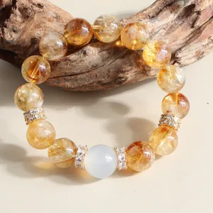 High-quality macro detail of a natural yellow crystal beaded bracelet with white bead