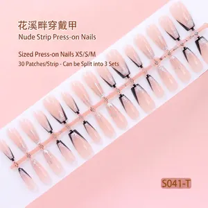 Detailed view of 30pcs nude gradient press-on nails with black French tips and glitter.