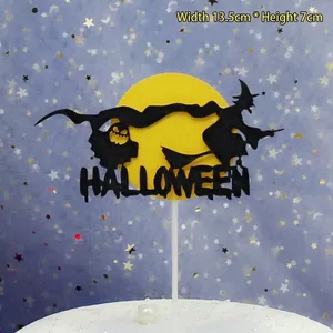 Macro view of a Halloween cake topper featuring a black witch and yellow moon.