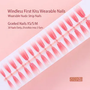 Macro view of 30-piece pink gradient press-on nail strip for professional DIY manicure