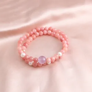 Close-up of pink stone double-layer bracelet with pearls and purple bead detail