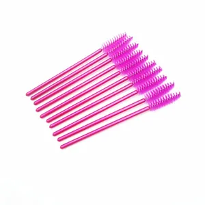 Set of vibrant magenta disposable eyelash brushes for professional makeup application