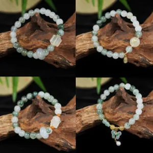 Macro view of four variations of jade bead bracelets with unique decorative charms.