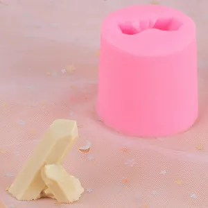 Detail view of pink silicone mold with a finished rock-shaped resin or fondant piece