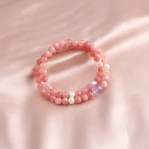Detailed view of a new Chinese style double-loop beaded bracelet with pink crystals and pearls.