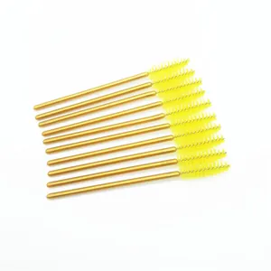 Disposable yellow eyelash brushes set with metallic gold handles for makeup application