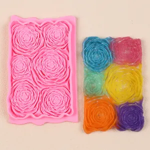 Detail view of pink rose silicone fondant lace mold and colorful finished cake decor