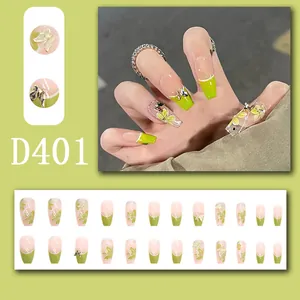 Detail view of green floral press-on nails featuring 3D butterfly charms and 24 pieces