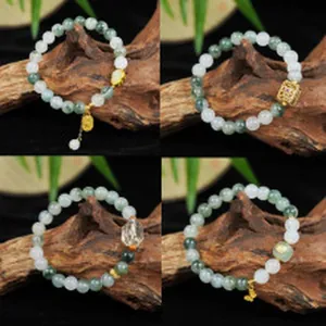 Detailed display of four natural green and white beaded bracelets with various gold charms.