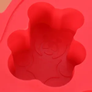 Close-up detail of the bear-shaped cavity in a red silicone ice cube mold for baby food