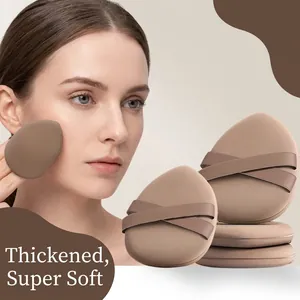 Close-up of thickened teardrop-shaped makeup puff with ribbon strap for seamless application